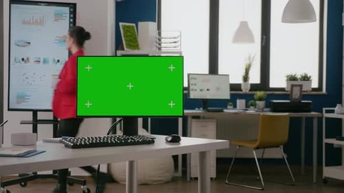 Computer with Green Screen on Display at Empty Office