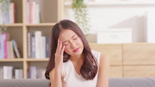 Young Woman Experiencing Headache at Home