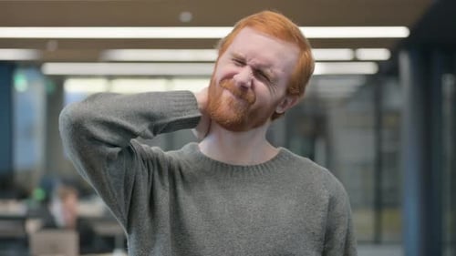 Man Experiences Neck Pain in Office Environment