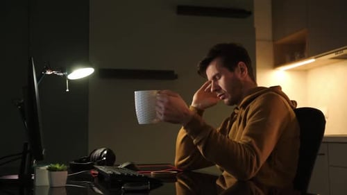 Young Adult Man Works Late at Computer