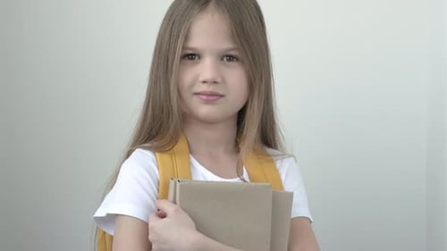 Portrait of Pretty Cute Smiling School Girl in White Tshort with Yellow Backpack and Books on Gray