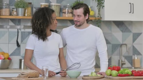 Couple Preparing Food Together in Bright Kitchen