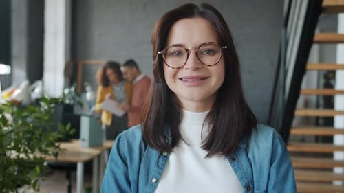 Smiling Woman in Modern Office Workplace Environment