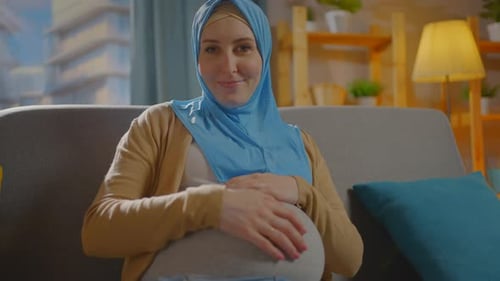 Pregnant Woman Resting Hand on Belly at Home