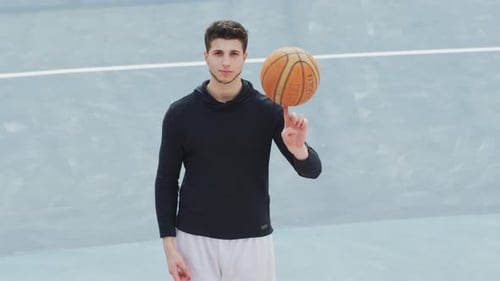 Basketball player spinning the ball on his finger