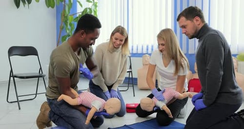 Adults Learning Infant CPR Techniques in Classroom Setting