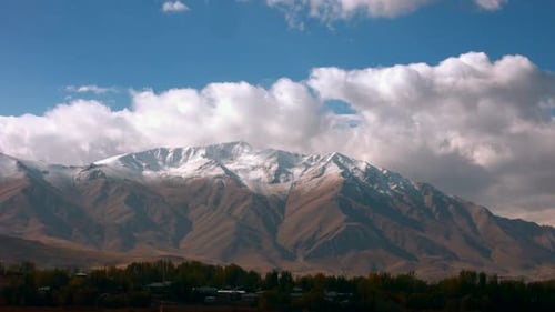 Scenic Mountain Range Under Blue Sky and Clouds