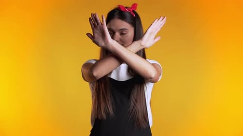 Girl Disapproving with No Crossing Hands Sign Make Negation Gesture. Denying