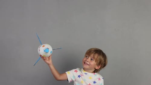Child Plays With a Homemade Rocket Toy Indoors