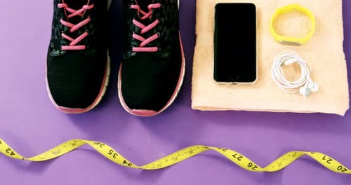 Fitness Accessories Still Life on Purple Background