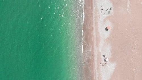 Top aerial view of sea coastline with sandy beach and clear turquoise water
