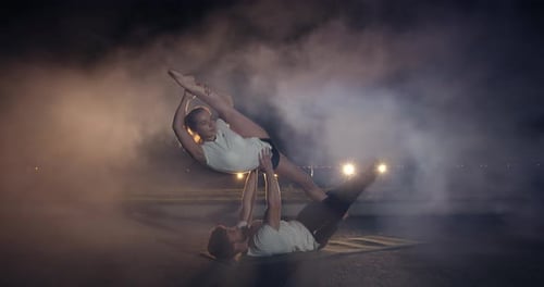 Male and Female Gymnasts Are Performing Outdoors Smoke in the Background