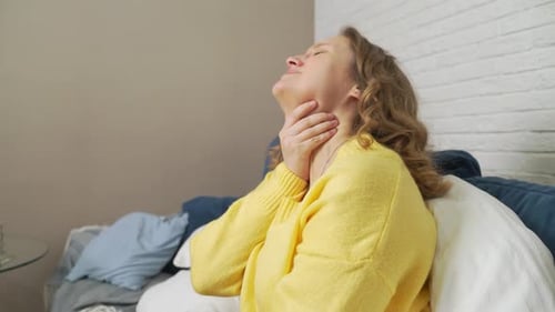 Woman Resting on Couch Feeling Unwell