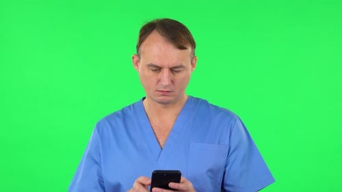 Happy Medical Man Texting on Him Phone, Green Screen