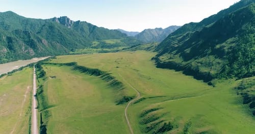 Aerial Rural Mountain Road and Meadow at Sunny Summer Morning