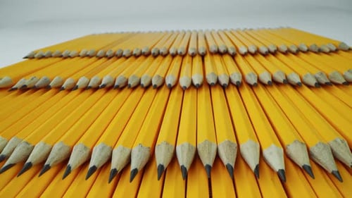 Yellow Pencils Lie on Top of Each Other in Even Rows