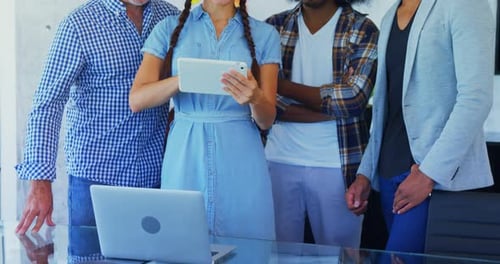 Colleagues Reviewing Data on Tablet in Office