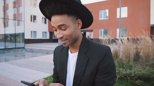 Stylish Young Man Using Phone Outdoors in City