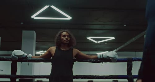 Young Adult Boxer with Coach in Boxing Ring