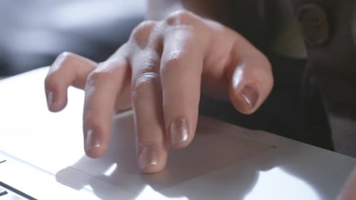 Woman's Hand Using Laptop Trackpad, Close Up