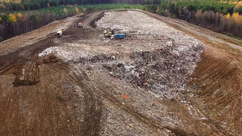 Garbage Trucks Unload Household Waste at the Landfill