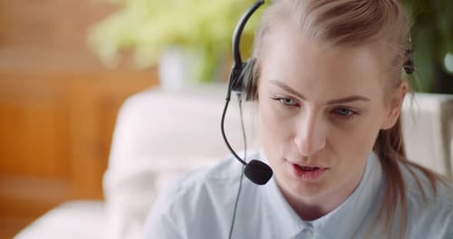 Woman Working From Home Wearing Headset