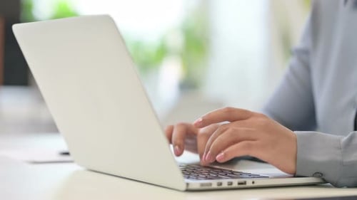 Close Up of African Woman Typing on Laptop