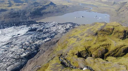 Drone approaching a waterfall at Solheimajokull glacier in Iceland