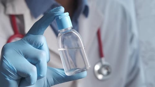 Close Up of Doctor Hand Holding Hand Sanitizer