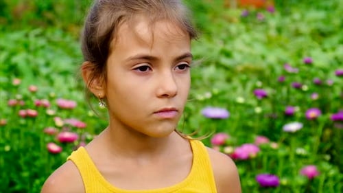 Girl Blowing Nose in Flower Filled Field