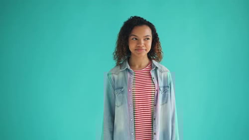 Smiling Woman in Denim Jacket Winks at Camera