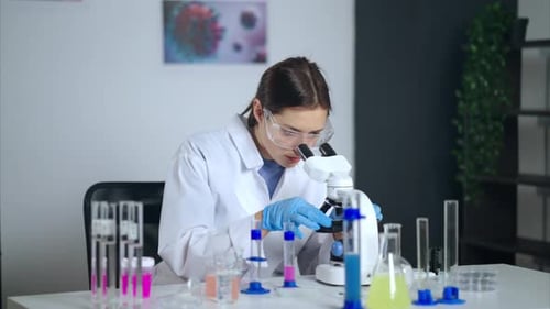 Female Scientist Using Microscope in Lab Setting