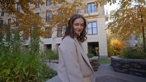 Woman Smiling in Urban Autumn Scene