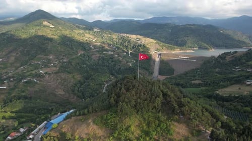 Scenic Hills Landscape With Red and White Flag