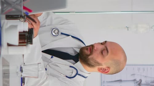 Vertical Video Doctor Looking at Camera Smiling During Brainstorming
