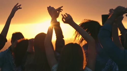 Friends Dancing at Sunset Rooftop Party