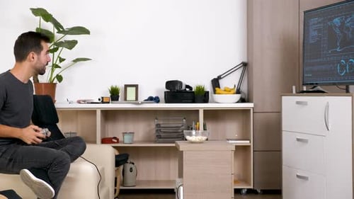 Man Playing Video Game on Couch