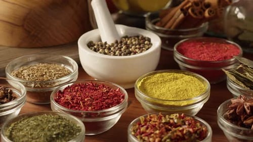 Assorted Dried Herbs and Spices in Glass Bowls
