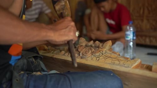 Craftsman Carving Wood in Traditional Balinese Workshop