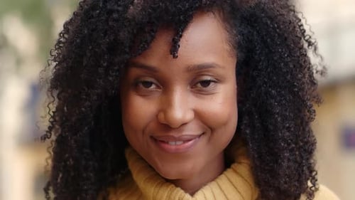 Closeup of an African American Woman Looking at Camera Smiling