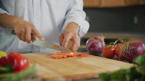 Close up shot of man cutting tomato