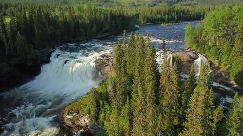Breathtaking Waterfall Flowing Through Green Forest