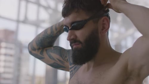 Man Puts on Swim Goggles Close Up