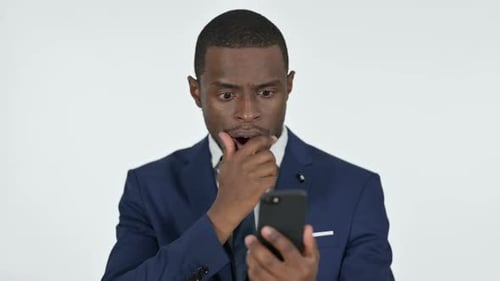 Young Adult Man Worried at News on Mobile Phone
