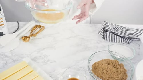Mixing Cookie Ingredients in Bowl on Marble Counter