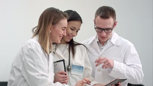 Medical Professionals Working Together Looking at Tablet