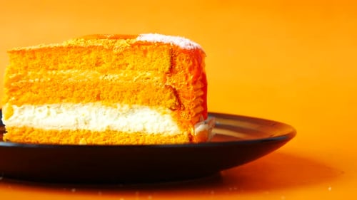 Orange Flavor Chocolate and Cream Cake on a Plate on Table