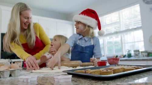 Family Baking Christmas Cookies Together in a Kitchen