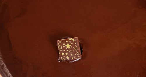 Chocolate Square Drops Into Glossy Molten Chocolate