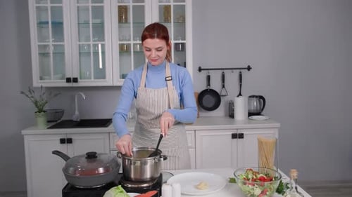 Woman Cooking Spaghetti in Bright Kitchen